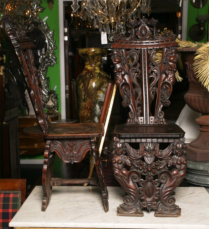 Pair of Italian carved oak Sgabello side chairs, of typical form each having shaped backrests and carved stiles depicting figures of women, the legs similarly carved. 

After 43 years of business we are retiring. Everything must be sold. Many of