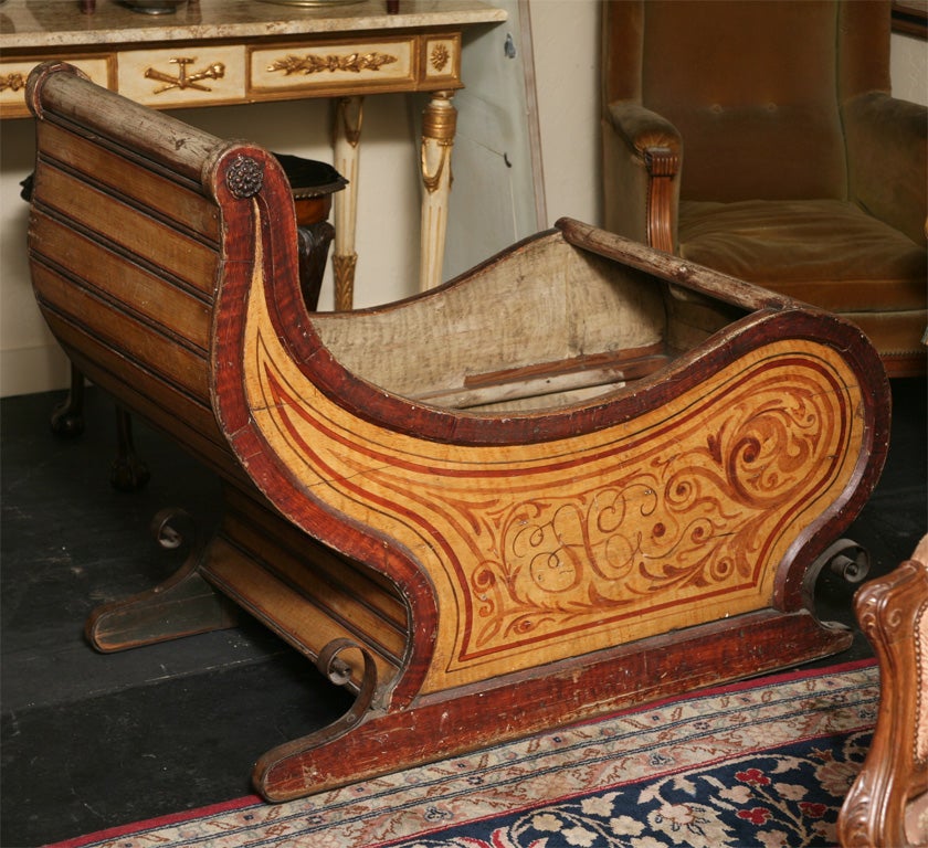 Antique Dutch sled, the scroll-shape super-structure with plank seat and front; the conforming solid panel sides painted with scroll-work, raised on shaped plinth with iron runners.

After 43 years of business we are retiring. Everything must be