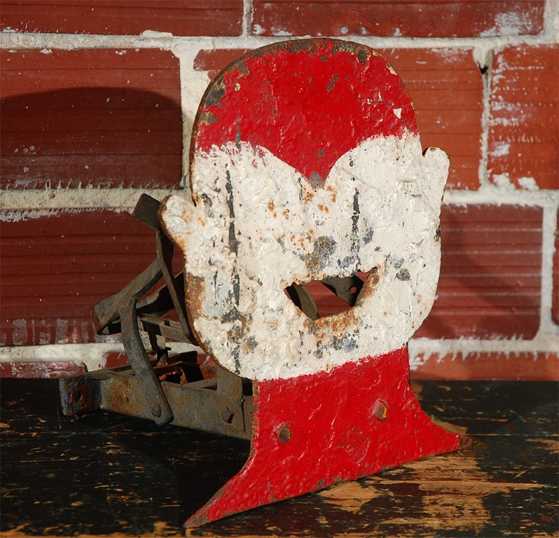 Sheet iron carnival shooting gallery target in the shape of a clowns head. Not marked, but thought to have been made by the Macglashan Air Gun company in California. Target still has the bell Apparatus on the back. Entire shooting gallery was found