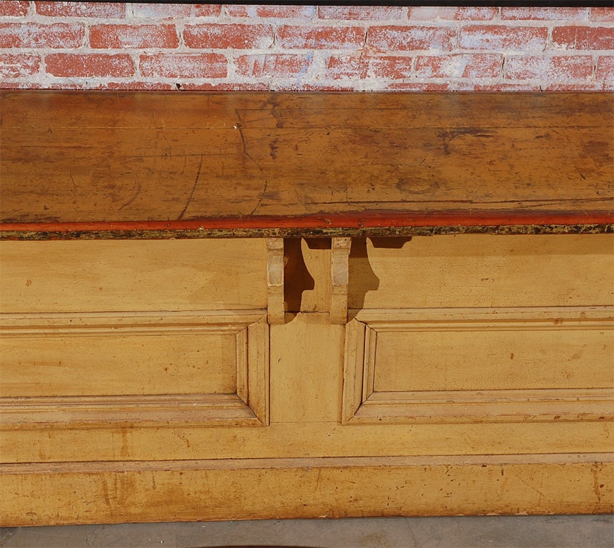 Sturdy general store counter found in Pennsylvania.  One of two available.  Great architectural elements and superb surface.  Original mustard paint.  Very smooth top and edges with an open back.  One with a shelf and one without.  Please inquire