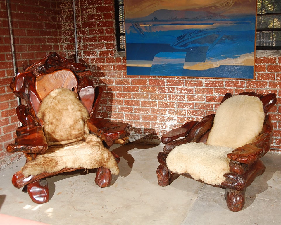 A large scale high back club chair by John Lovelle. made in a folk art hunting lodge style with hand made construction of solid free edge planks and branches from redwoods and a fitted sheep skin throw as upholstery.