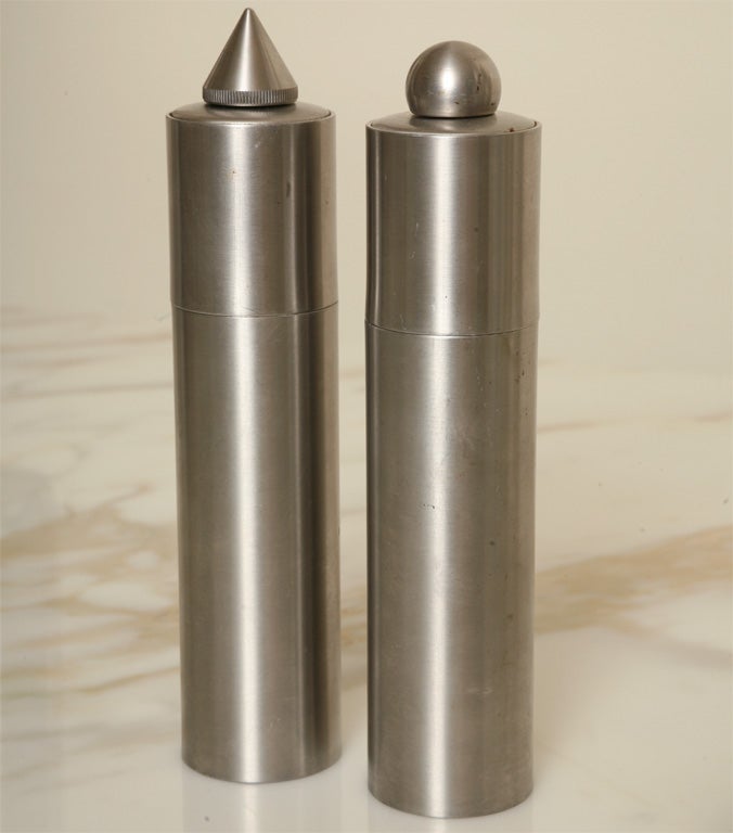 Pair of industrial stainless steel salt and pepper mills-one with cone top and one with ball top. Interior has 