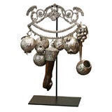 Silvered Milagros on metal stand