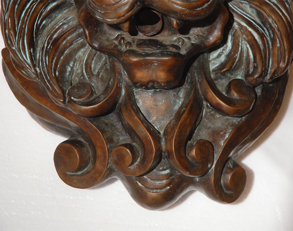 Cast bronze lions head spitter modelled after an Italian original. Antique bronze finish.