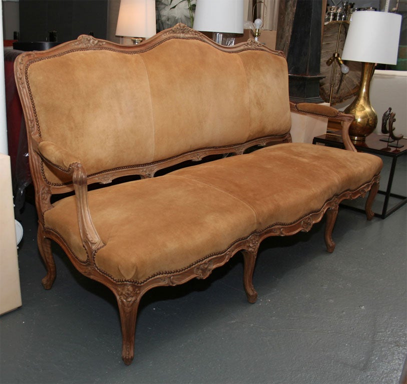 High back sofa, upholstered in tobacco suede

(Earlier gilding and paint work removed).