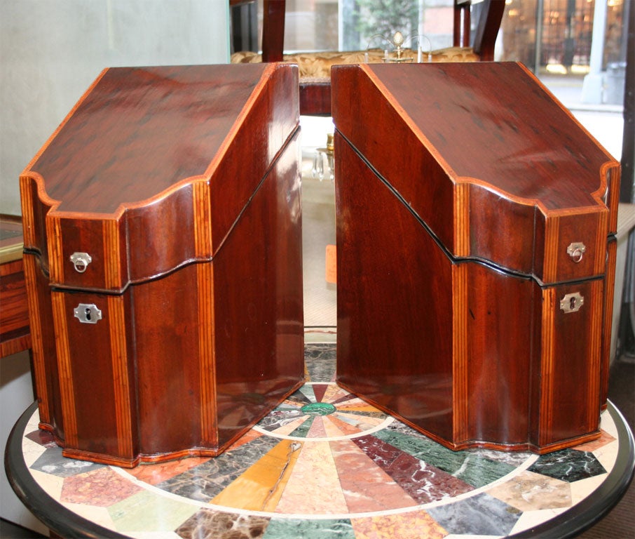 Fine pair of mahogany inlaid knife boxes with inlaid and fitted interior with silver escutcheons.