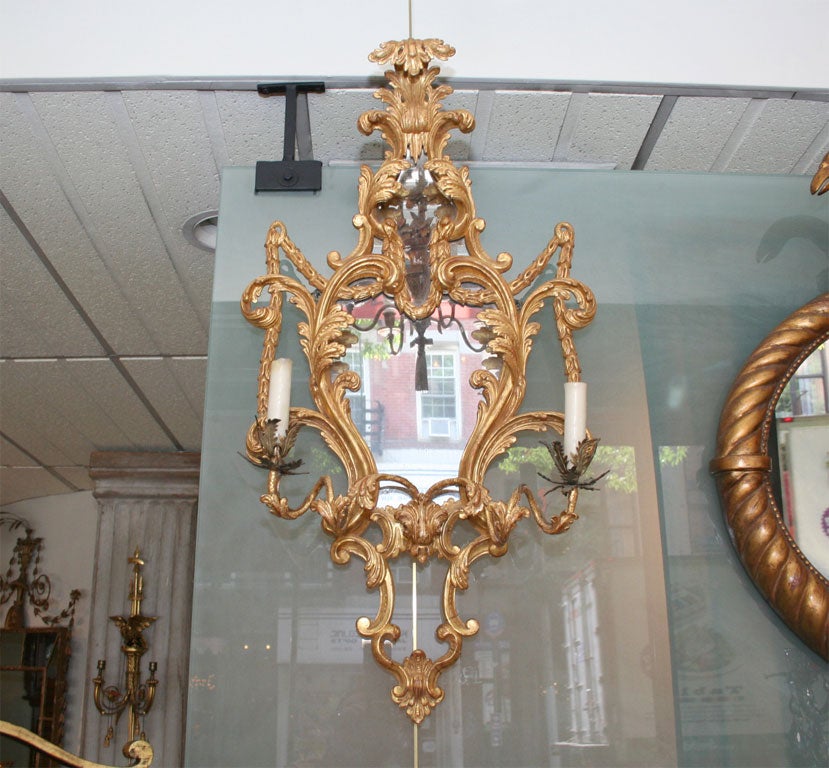 Fine pair of Rococo carved giltwood two-light Girandoloe mirrors.