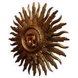 Flamboyantly Carved Giltwood Double Sunburst Mirror