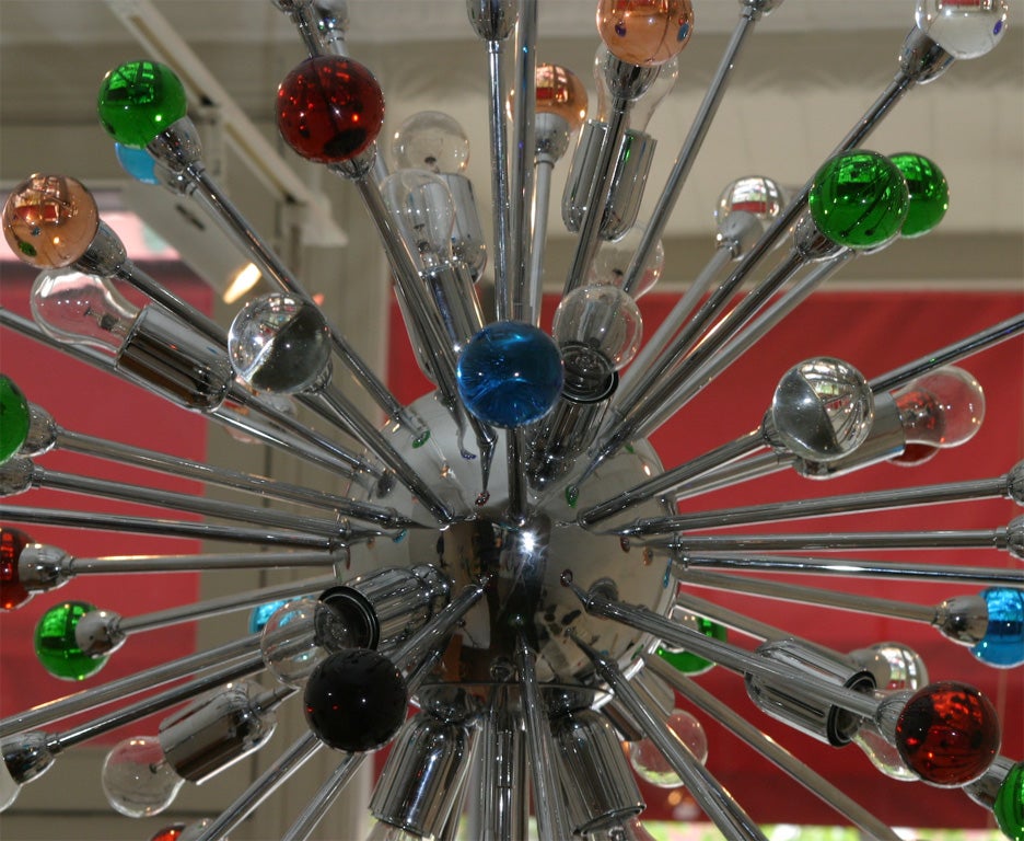 Large sputnik chandelier with 16 light sockets and 57 rods of two lenghts ending with different color glass spheres.