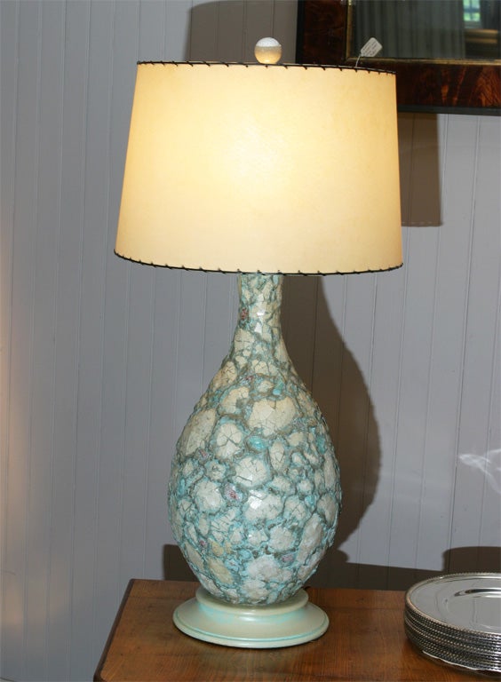 large pottery lamp<br />
crackled egg shell colored clusters<br />
intermingled with turquoise and deep red crackled chunks<br />
interlaced with a silver / gold metal style medium<br />
on a paint decorated wood base<br />
surmounted with