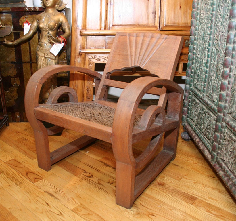 Pair of Dutch Colonial Java Indonesian Art Deco arm chairs club chairs. Teak wood with a woven bamboo seat. Carved back and rounded arms. Size is 27