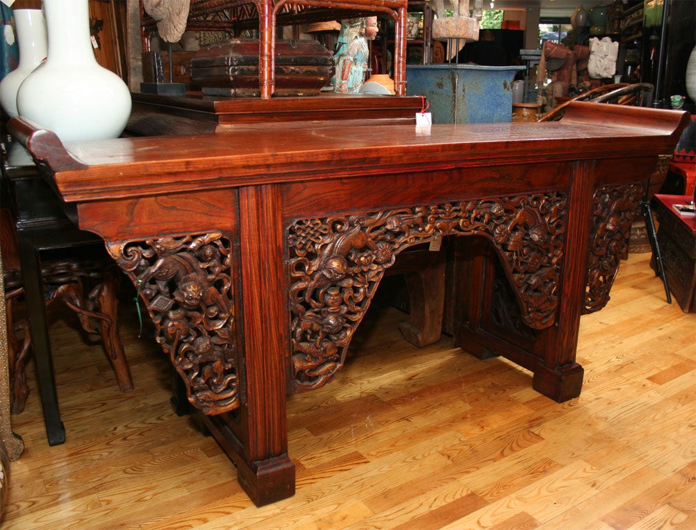 Chinese Qing Dynasty 18th century carved elmwood altar table console. The alter table has incredablely detailed panels featuring foo dogs.