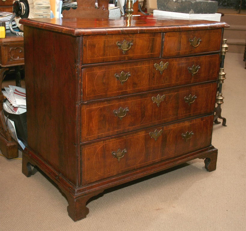 Period William and Mary yew wood and yew veneered chest of two over three drawers, the top with oval and heart inlay and solid thumb molded edge, oval string inlaid work on each of the  drawer fronts, standing on bracket feet.