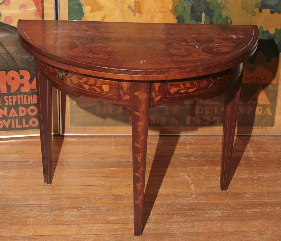 Demi-lune game table, in fruitwood inlaid with satinwood, bellflowers on the outside and checkerboard with playing cards inlaid on the inside.