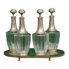 A SET OF FOUR CARAFES ON A MIRRORED PLATEAU,  C. 1850