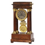 Antique French Empire mahogany and bronze mantle clock.
