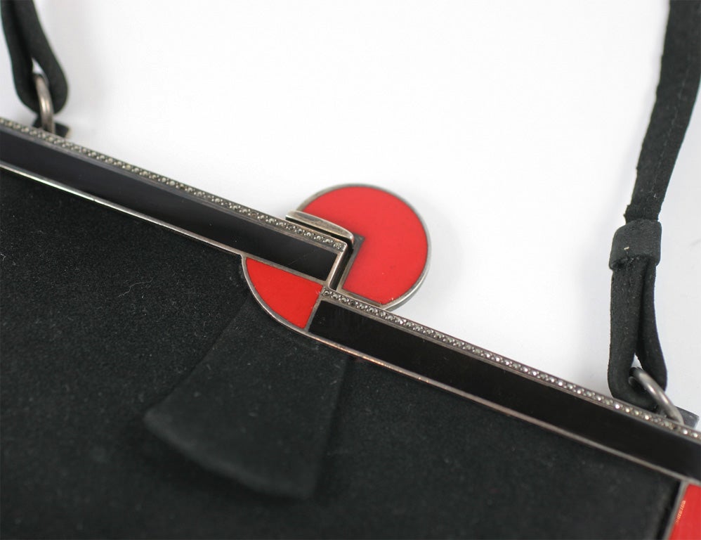 Art Deco Suede Evening Handbag with Red and Black Enamel on Silver frame with geometric Art Deco styling.  Excellent condition.  Minor area of suede loss at one clasp corner.  Some teeny tiny marcasite missing but included with hand bag if buyer