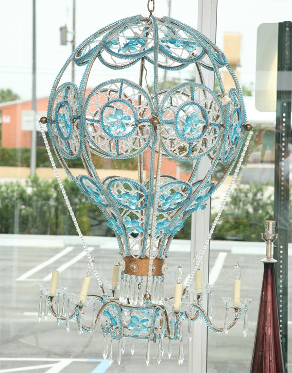 Magnificent turquoise blue and colorless crystal hot air balloon chandelier. The fixture has 6 arms with candelabra bulbs.