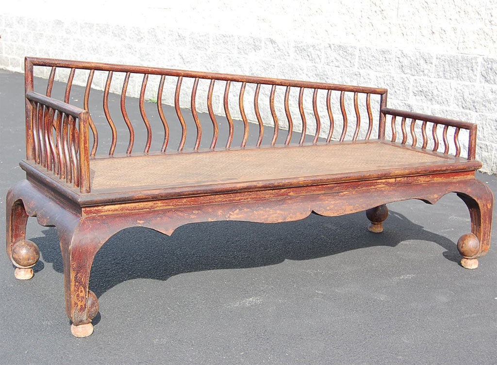 Mid-late 19th century Qing dynasty Shanxi opium bed with caned seat and slatted back and sides.