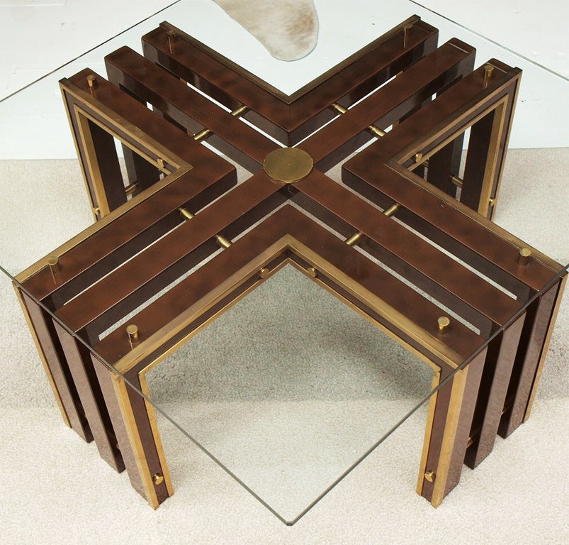 Cruciform coffee table in brown lacquered wood with solid brass trim and spacers