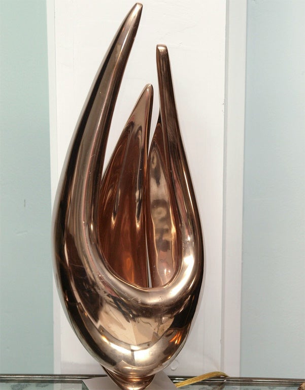 Exceptional table lamp by Michel Dumas in bronze of stylized flambeau form on a polished steel base