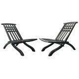 A pair of black folding side chairs