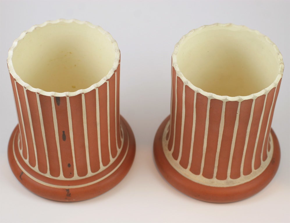 A rare pair of Wedgwood & Bentley pillar vases, the white terracotta biscuit fluted with rossa antico slip decoration, Wedgwood & Bentley mark