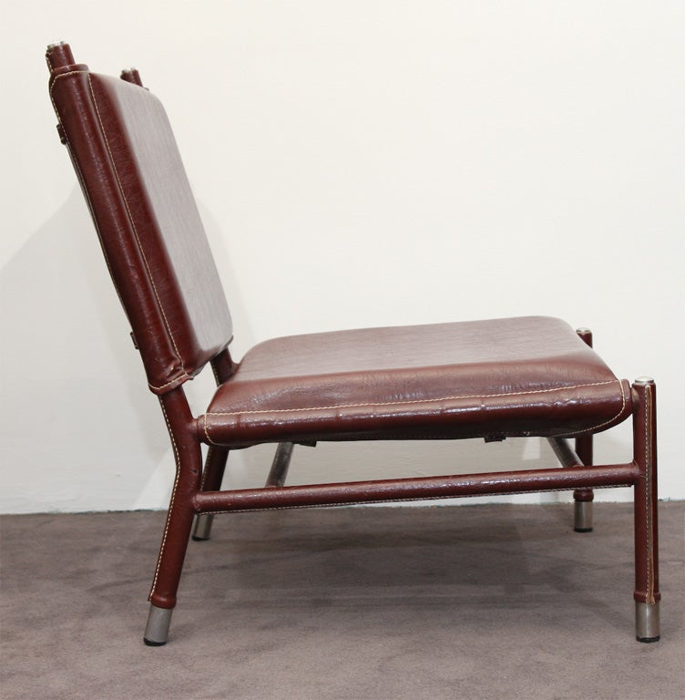 Pair of slipper Chairs by Jacques Quinet (1918-1992).<br />
Original plum leatherette, saddle stitching & metal.<br />
<br />
Seat : 23” x 23”  -  Seat H : 13 ½”