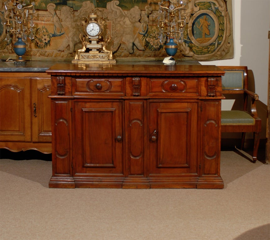 A walnut credenza with five sliding drawers and carved acanthus leaf details, the two cabinets below with paneled doors rests on carved molded base. 

William Word Fine Antiques: Atlanta's source for antique interiors since 1956.