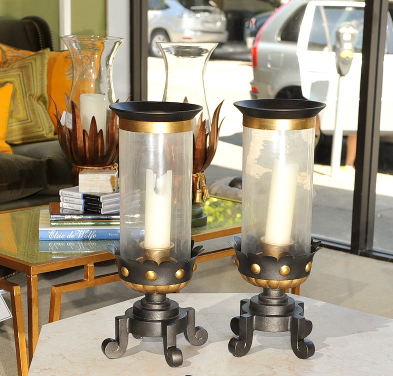 Direct from BeeLine Home by Bunny Williams, this pieces is Medieval in feeling but 20th Century in style. This 1940’s inspired hurricane has a weighted forged iron base. The parcel gilt, gadrooned and stylized floret body supports a metal capped,