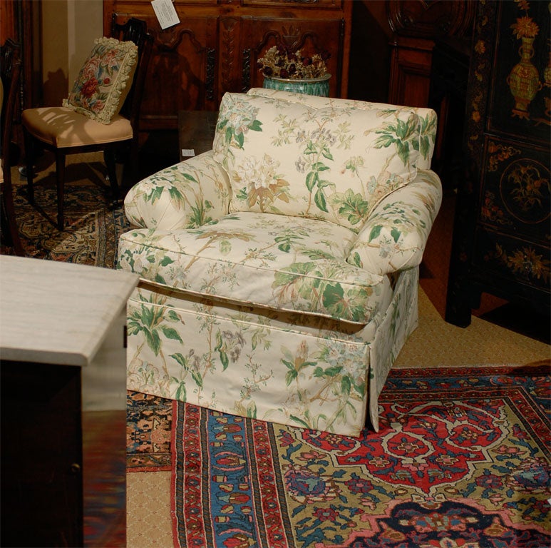 New Lee Jofa Durham chair frame upholstered in a green and white floral Lee Jofa fabric.  The arm chair is skirted and has a pillow back.