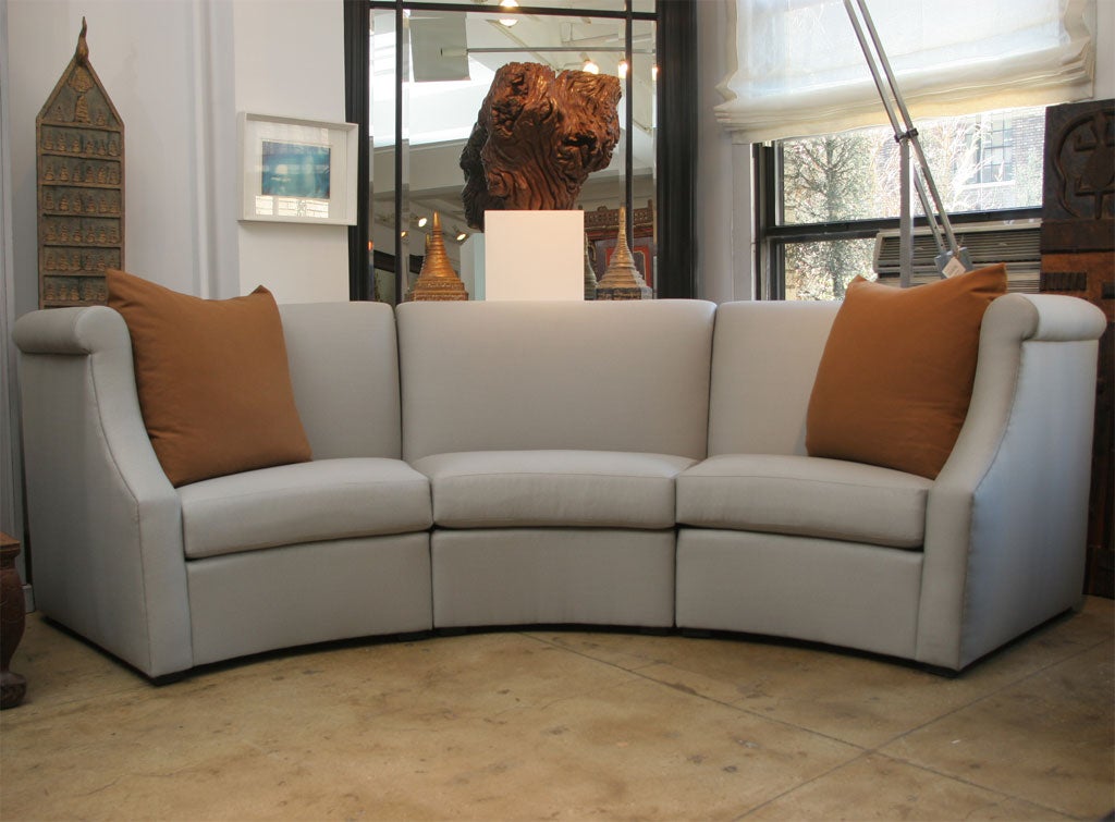 The Vicente Wolf Designed, Curved high rolled arm sectional sofa with tight back and three loose seat cushions. COM requirement: 27 yds. 10-12 Week lead time.
