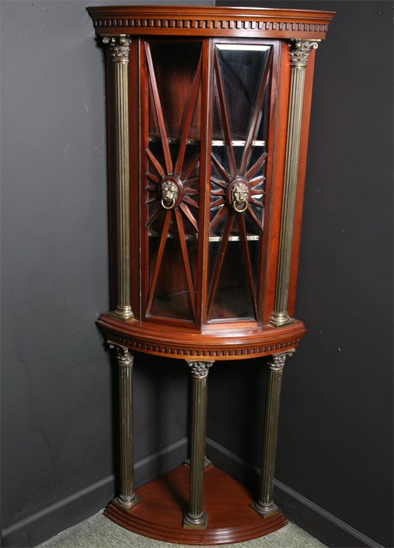 A glazed top corner cabinet