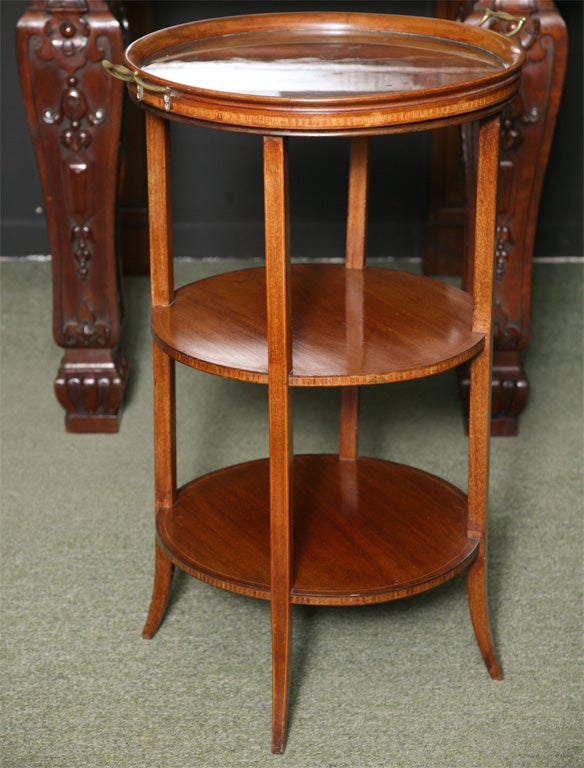 A three tier occasional table with a tray top.