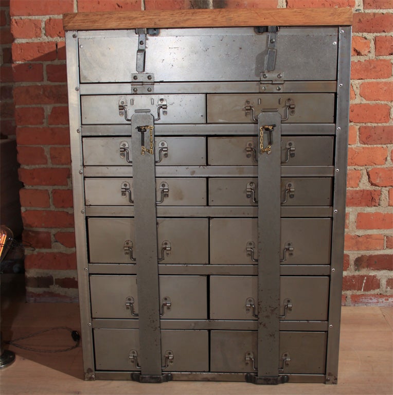 Industrial locking military filing cabinet. Perfect kitchen, sideboard storage piece. Pair to featured cabinet has added base with casters, and maple top.