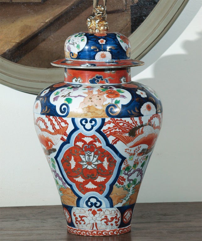 Wonderful large pair of imari coved jars with foo dog finials. Great unusual coloration with peach touches.
