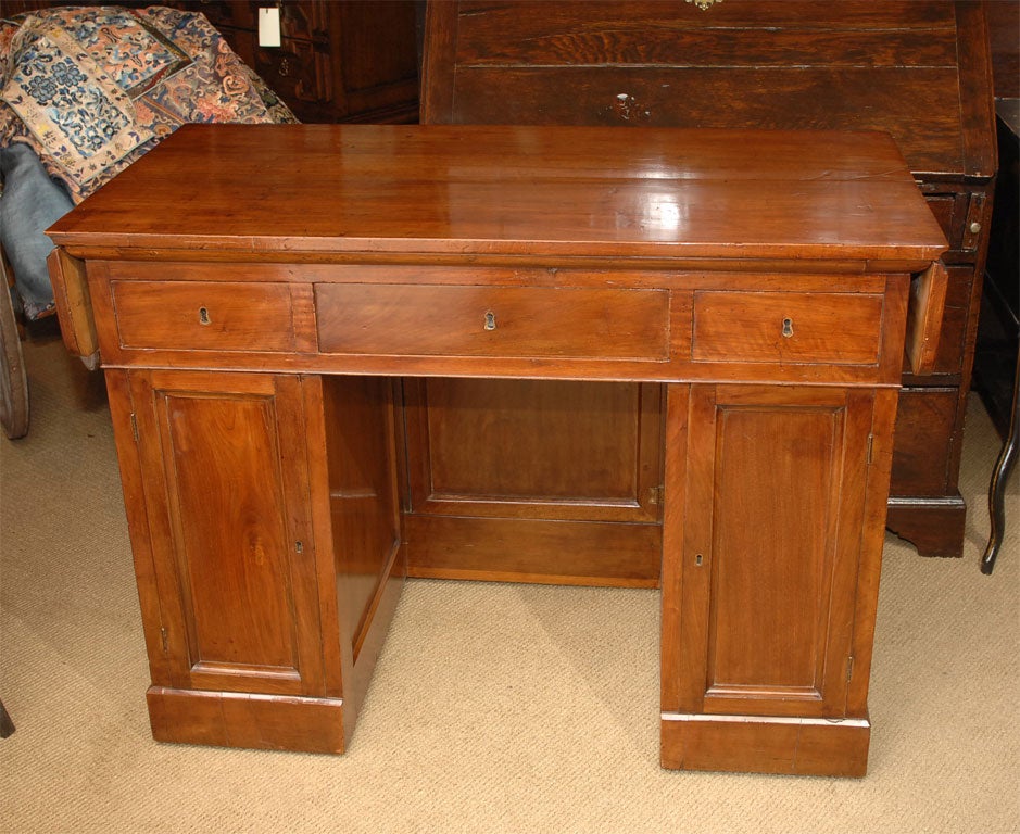 A charming drop-leaf knee hole desk. Made in Italy during the first part of the 19th century. Beautifully finished on all four sides so it would look great sitting in the middle of a room. This desk also has a modesty panel that can be opened. There