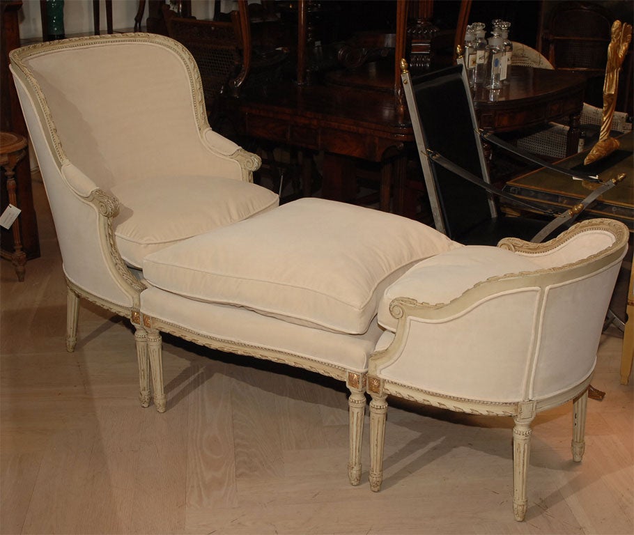 A very nice late 19th century Louis XVI style Duchesse Brisee in three parts. The frames carved painted and giltwood upholstered in ivory cotton velvet.  The upholstery is new.  The frames are in excellent shape.