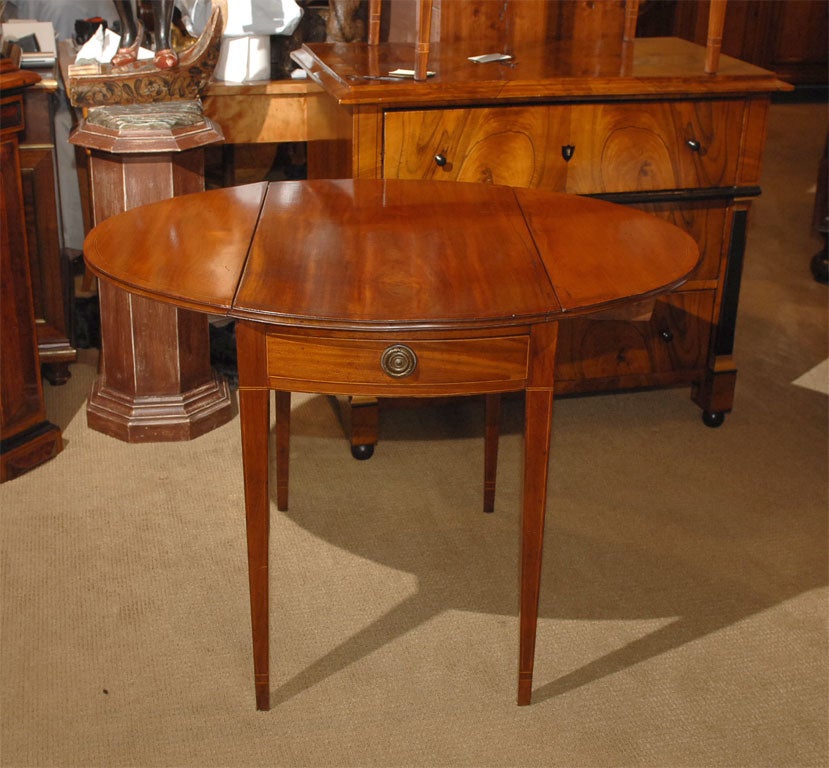 A rare pair of Federal period oval mahogany inlaid Pembroke tables.  Probably made in New York.