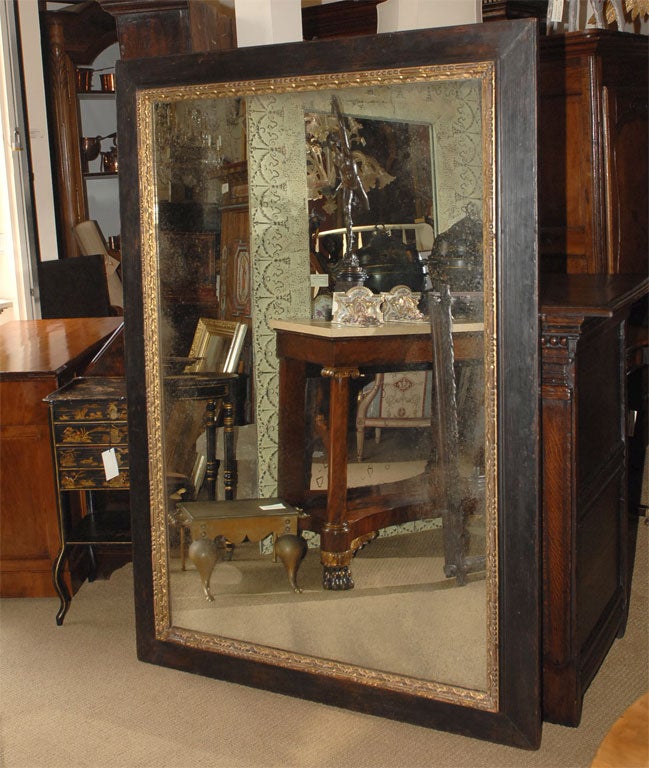 A Large Ebonized Painted and Gilt Wood Baroque Mirror