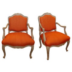 Painted French bergeres with orange upholstery