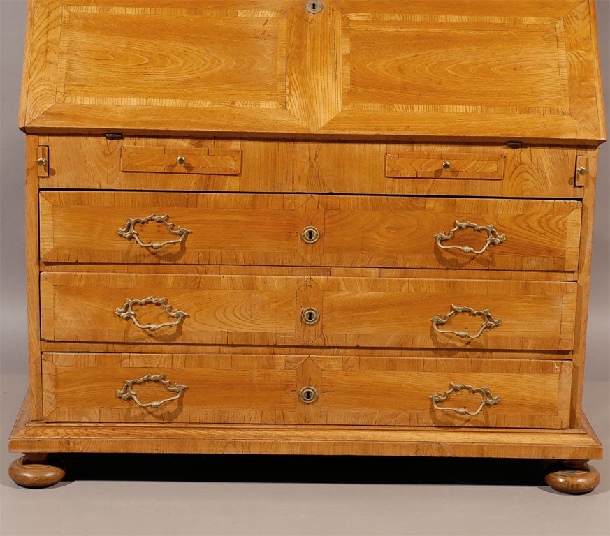 A Biedermeier period ash Bureau bookcase with crossbanding and bun feet, originating in Germany during the first quarter of the 19th century.

For many more fine antiques, including an extensive inventory of Biedermeier pieces, please visit our