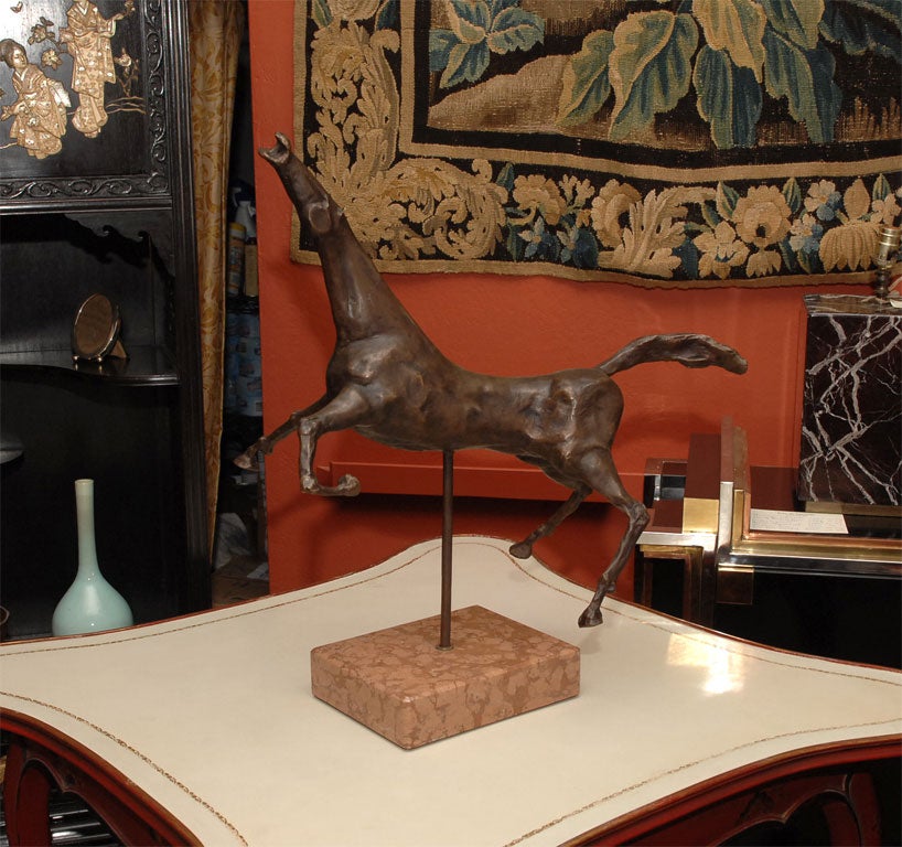 With an elongated neck in a galloping pose attached to a marble base, with original patina.  This piece was cast at Ferdinando Marinelli's Artistic Foundry in Rifredi (Florence).