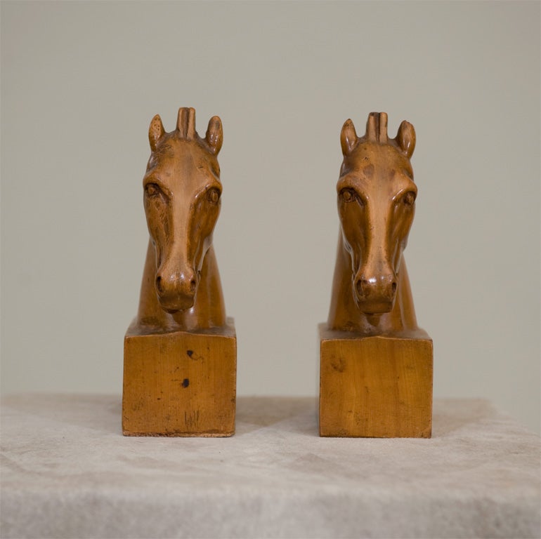 A Pair of Late 19th/Early 20th Century Fruitwood Carved Horse Bookends with cork bottoms.