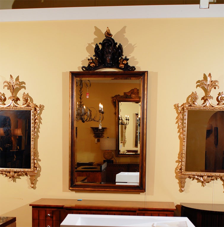 Wonderful 19th century Black Forest deer head carving used as a cornice on this large mirror.  Frame is new, made in Italy.  Rich dark browns and gold gilding on accents in carving with the frame being a medium brown with antiqued gold trim.