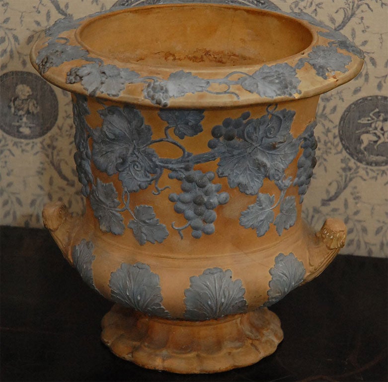 This cachepot is very unusual by it color  and fine details of grapes