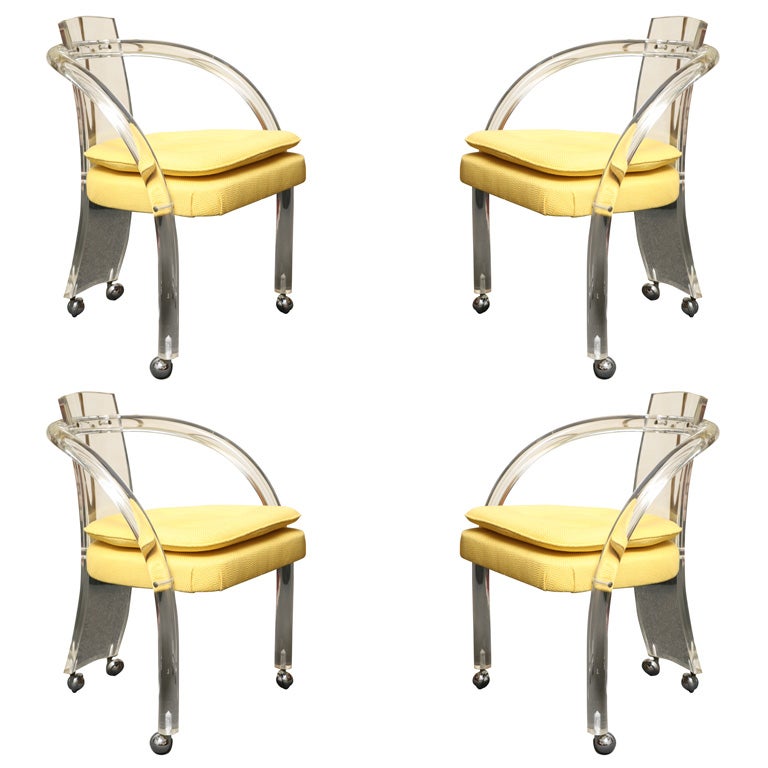 Four Lucite Curved Arm Chairs on Casters