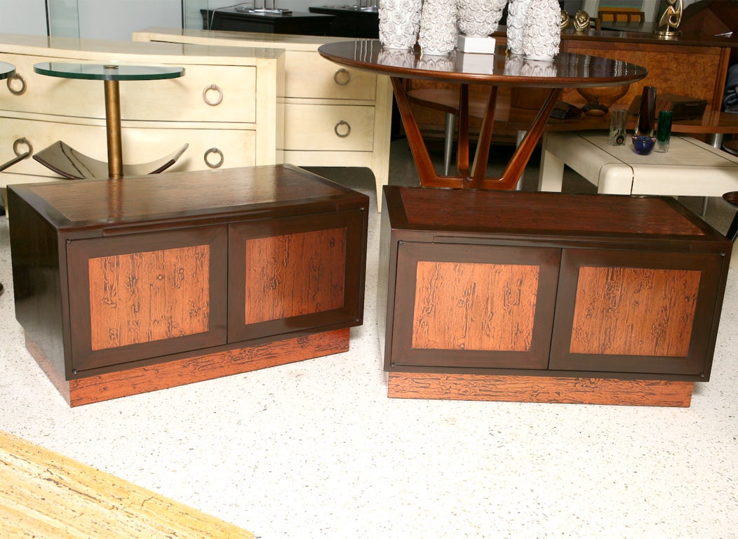 The rectangular dark walnut top with large copper panel inserts above two doors similarly decorated, the interiors well fitted and with a writing slide revealed from the top.