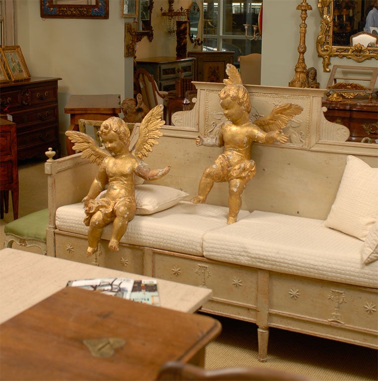 Pair of carved and gilded 18th Century winged putti.