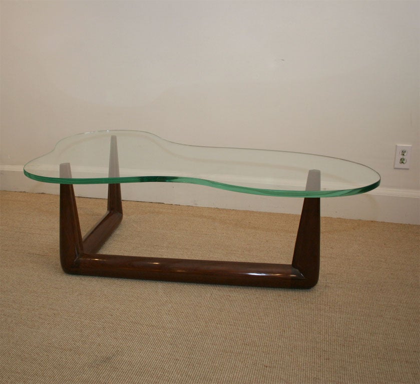 A Robsjohn-Gibbings Free-form Wood & Glass Table.